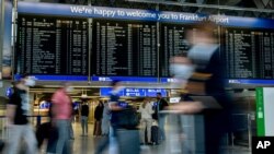 FILE - Passengers walk in a terminal at the airport in Frankfurt, Germany, Aug. 27, 2020.