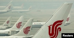 FILE - Air China planes are seen on the tarmac of the Beijing Capital International Airport, July 11, 2011.