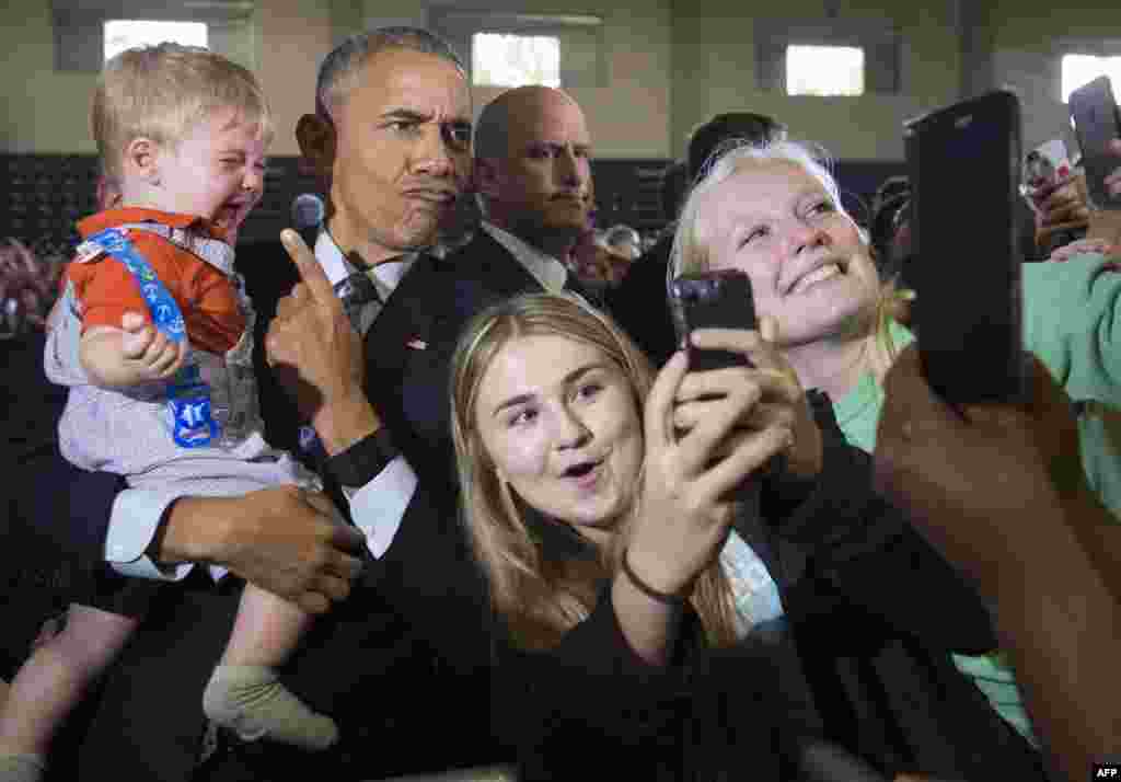 U.S. President Barack Obama holds 10-month-old Brooks Breitwieser as he greets supporters during a Hillary for America campaign event for Democratic Presidential nominee Hillary Clinton at the Capital University Field House Columbus, Ohio, Nov. 1, 2016.