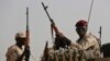 FILE - Sudanese soldiers from the Rapid Support Forces unit, led by Gen. Mohammed Hamdan Dagalo, the deputy head of the military council, secure the area in the East Nile province, Sudan, June 22, 2019. 