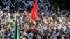 Thousands of Sunnis and Shi'ites from across Kuwait take part in a mass funeral procession for 27 people killed in a suicide bombing that targeted the Shi'ite Imam Sadiq Mosque a day earlier, at Kuwait's Grand Mosque in Kuwait city, June 27, 2015. 