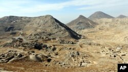 FILE - A general view of Mes Aynak valley, 40 kilometers (25 miles) southwest of Kabul, Afghanistan. The Afghan government is trying to grab President Donald Trump’s attention by dangling its massive, untouched wealth of minerals, including lithium, the silvery metal used in mobile phone and computer batteries considered essential to modern life. There are also deposits of coal, copper and rare earth elements. 
