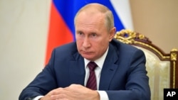 Russian President Vladimir Putin attends a meeting via video conference in Moscow, Russia, Thursday, Nov. 5, 2020. (Alexei Druzhinin, Sputnik, Kremlin Pool Photo via AP)