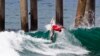 FILE -Sally Fitzgibbons, of Australia, competes on her way to a third place finish in the U.S. Open of Surfing, Aug. 5, 2012, in Huntington Beach, California. 