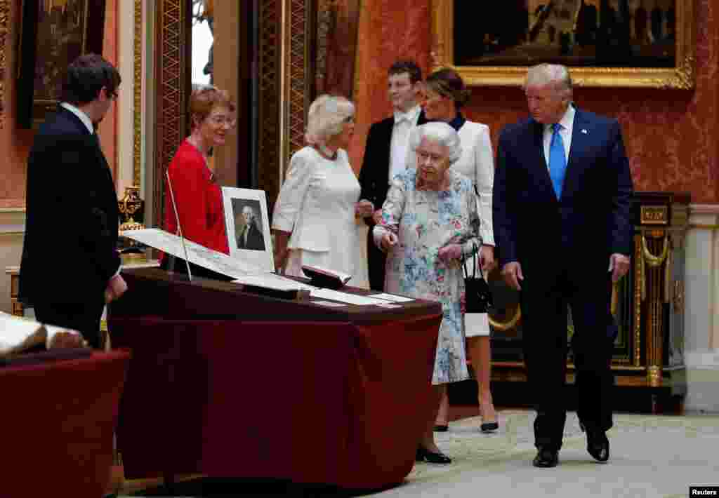 U.S. President Donald Trump and Britain's Queen Elizabeth review items from the Royal Collection at Buckingham Palace, June 3, 2019.