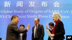 Marion Koopmans, kanan, dan Peter Ben Embarek, tengah, dari tim Organisasi Kesehatan Dunia mengucapkan selamat tinggal kepada mitranya dari China Liang Wannian, kiri, setelah Konferensi Pers Studi Bersama WHO-China diadakan di Wuhan, China. (Foto: AP)