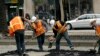 FILE- A crew works on a section of Market Street in San Francisco, Aug. 19, 2011. 