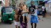 Sri Lankans living near St. Anthony's shrine run for safety after police found explosive devices in parked vehicle, which later exploded in Colombo, Sri Lanka, April 22, 2019.