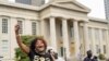 People react after a decision in the criminal case against police officers involved in the death of Breonna Taylor, who was shot dead by police in her apartment, in Louisville, Kentucky, Sept. 23, 2020.