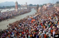 Hindu devotees gather on the banks of the River Ganges to take holy dips on the auspicious occasion of Somvati Amavasya in Haridwar, India, Monday, May 18, 2015. Somvati Amavasya is the no moon day that falls on a Monday in a traditional Hindu lunar calen