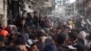 Palestinians line up to receive bread outside a bakery in Khan Yunis, Nov. 18, 2024, amid the ongoing war between Israel and Hamas.