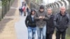 Migrants walk outside a camp in Rodgön, Germany.