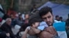 Young, educated, ambitious migrants could invigorate European economies, some contend. Here, a Syrian refugee cradles his child after reaching the northeastern Greek island of Lesbos, Oct. 4 , 2015.