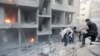 Men search for survivors at a site activists said was hit by heavy shelling by forces loyal to Syria's President Bashar al-Assad in the Douma neighborhood of Damascus June 16, 2015.