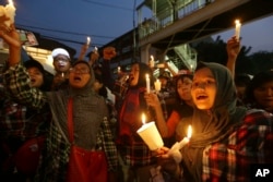 FILE - Supporters of Jakarta Gov. Basuki "Ahok" Tjahaja Purnama who is imprisoned for blaspheming Islam shout slogans during a protest outside the High Court in Jakarta, Indonesia, May 16, 2017.