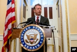 FILE - Sen. Rand Paul answers reporters' questions during a news conference on Capitol Hill in Washington, April 18, 2018.