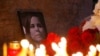 Flowers and candles are placed next to a portrait of Darya Dugina in Moscow