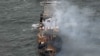 Smoke rises from damaged containers on the deck of the MV Solong cargo ship in the North Sea, off the coast of Withernsea, east of England, on March 11, 2025, after it collided with the MV Stena Immaculate tanker on March 10. 