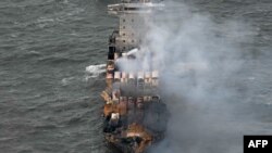 Smoke rises from damaged containers on the deck of the MV Solong cargo ship in the North Sea, off the coast of Withernsea, east of England, on March 11, 2025, after it collided with the MV Stena Immaculate tanker on March 10. 