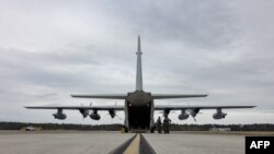 Marinir AS melakukan pemeriksaan pra-penerbangan pada KC-130J Super Hercules di Pangkalan Udara Korps Marinir Cherry Point, North Carolina, yang akan digunakan untuk mengangkut imigran tanpa dokumen ke Teluk Guantanamo. 
