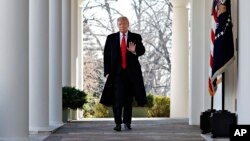 Predsednik Donald Tramp maše dok korača kroz Kolonadu Bele kuće, 25. januara 2019. (Foto: AP)