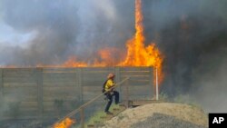 A brush fire burns at a shooting range on the beach at Navel Base Ventura County May 3, 2013