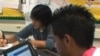 FILE - Students in Fairfax County, Virginia, use their online textbooks in class.