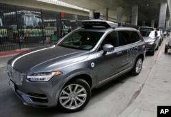 In this photo taken Dec. 13, 2016, an Uber driverless car heads out for a test drive in San Francisco.