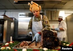 A U.S. Army soldier serves Thanksgiving meal to his comrades at the Resolute Support headquarters in Kabul, Afghanistan November 22, 2018.