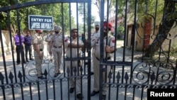 Police officers stand guard before the verdict on rape and murder of an eight-year-old girl in Kathua, near Jammu, inside a court premises in Pathankot, in the northern state of Punjab, India, June 10, 2019.