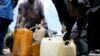 People sell black market fuel on the street in Lagos, Nigeria, May 30, 2023.