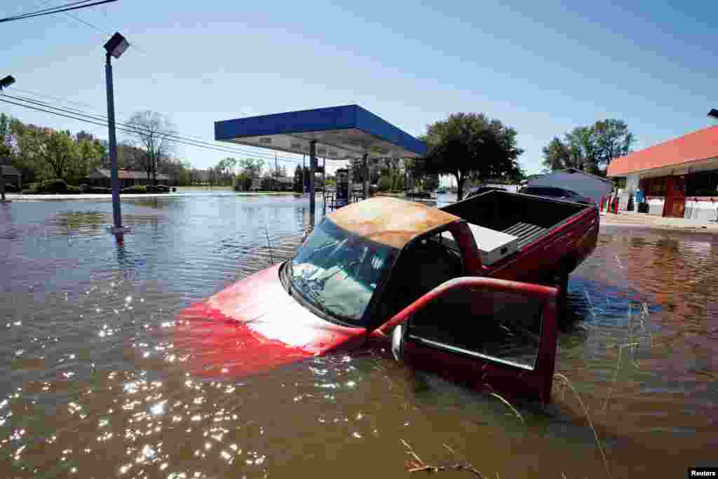 An abandoned truck lies in submerged waters after Hurricane Matthew hit Lumberton, North Carolina.