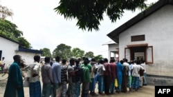 People stand in line to check for their names on the final list of the National Register of Citizens (NRC), in an office in Pavakati village of Morigoan district, in India's northeastern state of Assam, Aug. 31, 2019.