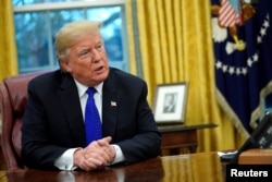 FILE - U.S. President Donald Trump sits for an exclusive interview with Reuters journalists in the Oval Office at the White House in Washington, Dec. 11, 2018.