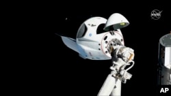 FILE - The SpaceX Crew Dragon capsule is pictured, March 3, 2019, about 20 meters (66 feet) from the International Space Station's Harmony module.