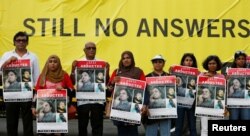 FILE - A group of Maldivians hold posters of disappeared Maldivian journalist Ahmed Rilwan Abdulla as they mark the "International Day of the Disappeared" in Colombo, Sri Lanka, Aug. 28, 2018.