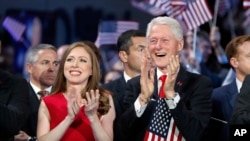 Chelsea Clinton and former President Bill Clinton applaud as Democratic presidential nominee Hillary Clinton speaks during the final day of the Democratic National Convention in Philadelphia, July 28, 2016.