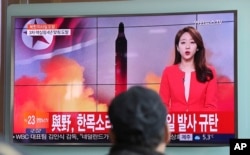 A man watches a TV news program reporting about North Korea's missile launch in Seoul, South Korea, Feb. 12, 2017. The letters read "The ruling and the opposition parties denounce North Korea's missile launch."