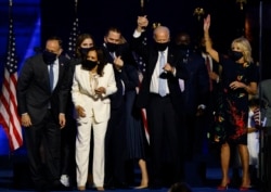 Democratic 2020 U.S. presidential nominee Joe Biden celebrates onstage at his election rally in Wilmington