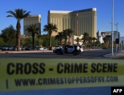 Crime scene tape surrounds the Mandalay Hotel (background) after a gunman killed at least 50 people and wounded more than 200 others when he opened fire on a country music concert in Las Vegas, Nevada, Oct. 2, 2017.