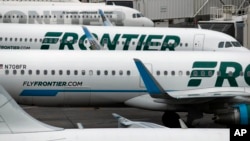 In this May 15, 2017, photo, Frontier Airlines jetliners sit at Denver International Airport in Denver.