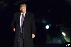 FILE - President Donald Trump walks on the South Lawn upon arrival at the White House in Washington from a trip to Florida, Feb. 12, 2017.