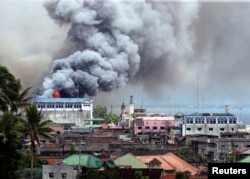 Black smoke comes from a burning building in a commercial area of Osmena street in Marawi city, Philippines, June 14, 2017.