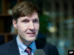 FILE - Martin Helme, son of Chairman of the Estonian Conservative People's Party (EKRE) Mart Helme, the party vice chairman and the leader of EKRE's parliamentary faction, speaks to journalists at the headquarters after parliamentary elections in Tallinn, Estonia, March 4, 2019.