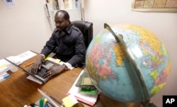 Sudanese refugee Suliman Bandas, who teaches English as second language, works in his classroom in Lincoln, Nebraska, Jan. 4, 2017.