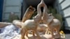 A seized handicraft item made of ivory sits near seized elephant tusks at a Malaysian customs office in Port Klang outside Kuala Lumpur.