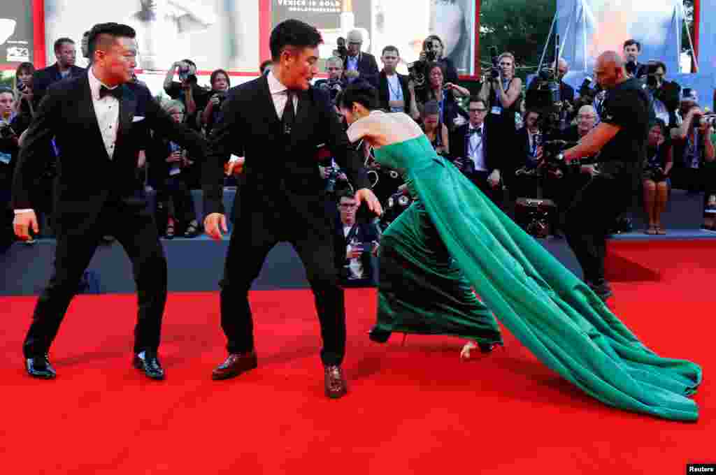 A guest falls during the red carpet event for the movie &quot;The Light Between Oceans&quot; at the 73rd Venice Film Festival in Venice, Italy.