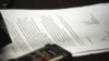 Ethiopia's Minister of Justice Berhan Hailu, unseen, reads aloud from a document appearing to be a petition for mercy by two Swedish journalists who have been imprisoned in Ethiopia for more than a year, and who Hailu announced have been pardoned and are set to be freed, at a news conference in Addis Ababa, Ethiopia, Sept. 10, 2012. 