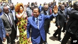 Cameroon's President Paul Biya waves outside a polling center after casting his vote in the capital Yaounde October 9, 2011.