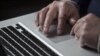 John Bumgarner, a cyber warfare expert works on his laptop computer during a portrait session in Charlotte, North Carolina, December 1, 2011.